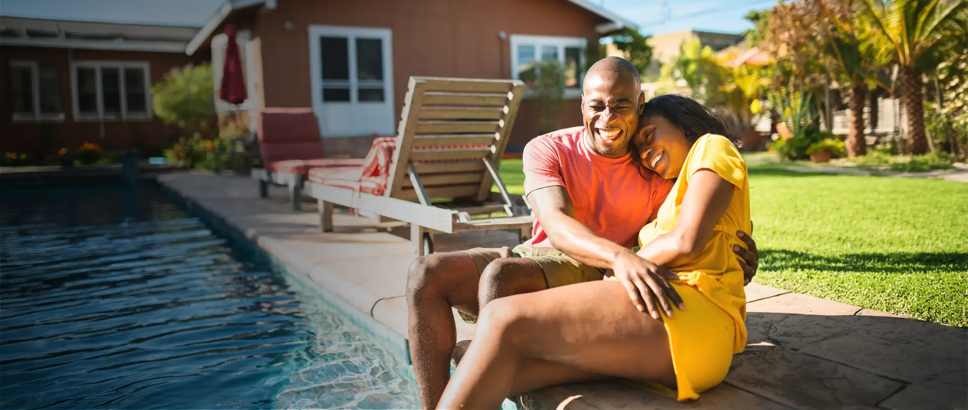 Couple enjoying a Granita™ Fiber pool — backyard ready