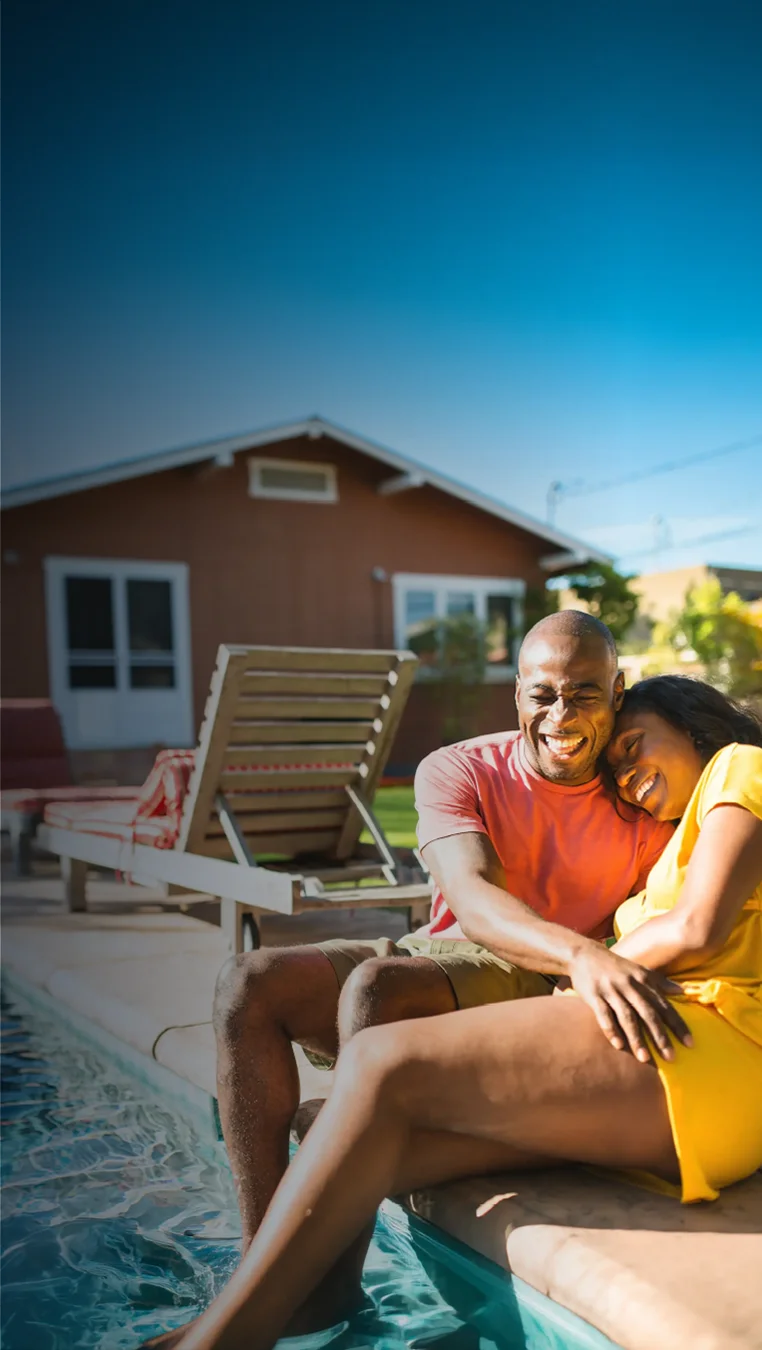 Couple enjoying a Granita™ Fiber pool — backyard ready